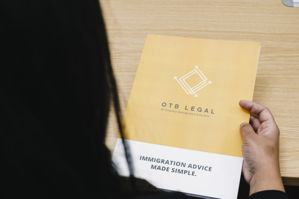 Woman reading OTB Legal Branded Leaflet