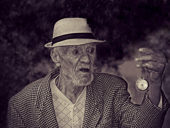 Elderly Man Holding Pocket Watch