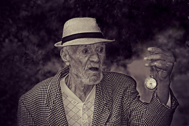 Elderly Man Holding Pocket Watch