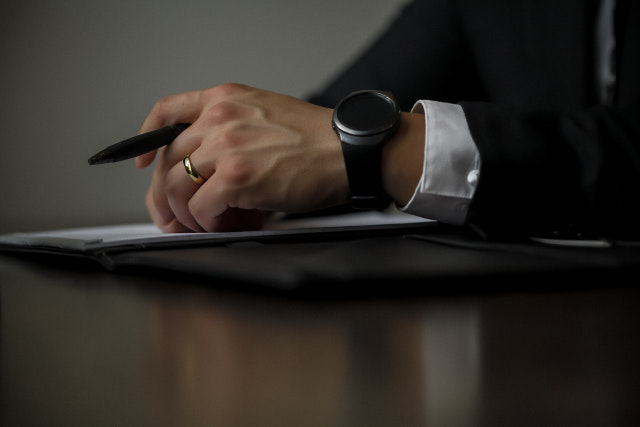 Lawyer With Smartwatch Holding Pen