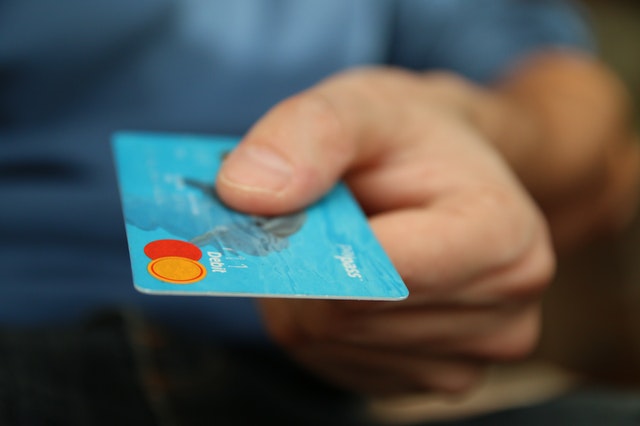 Person Holding Bank Card