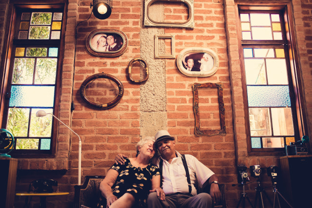 Old Couple Cuddled Up On Bench