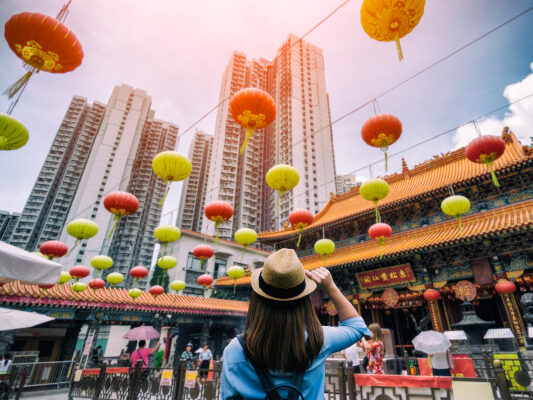 Person Looking Up At Hong Kong Buildings