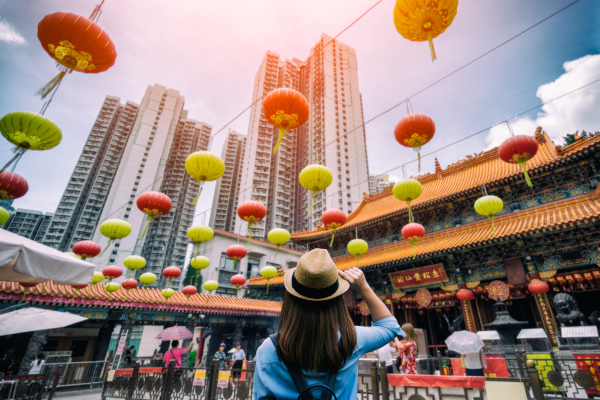 Person Looking Up At Hong Kong Buildings