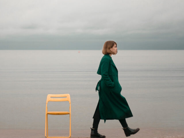 Walking Alone Along The Beach