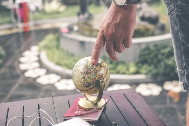 person holding terrestrial globe