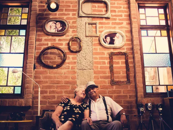 Old Couple Cuddled Up On Bench