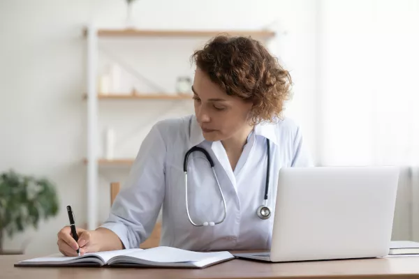 Doctor Filling Out Paperwork