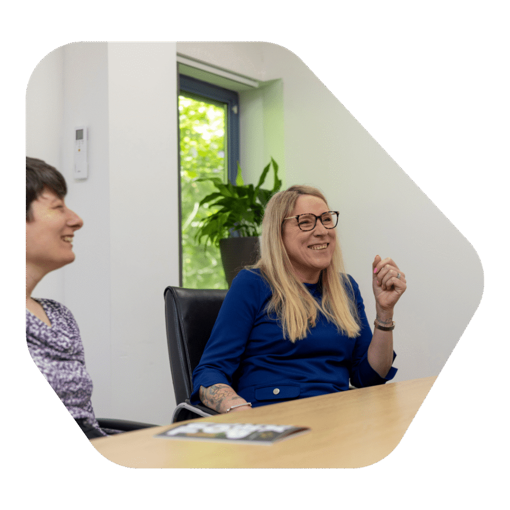 ward winning sponsor licence application solicitors sat at a meeting table and smiling