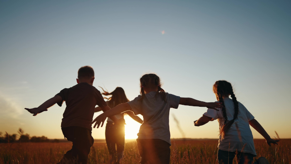 Immigration Law for children in care, kids running in a field