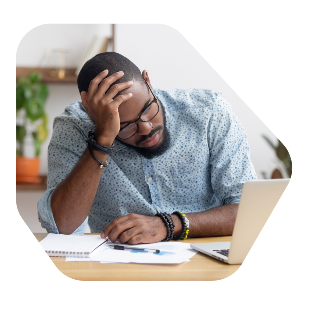 Man at desk making a UK Skilled Worker Visa Application 