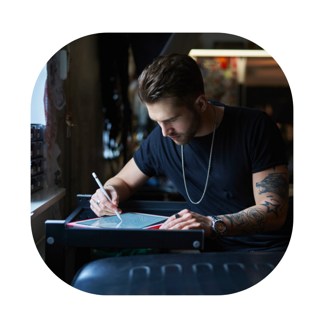 Man at desk creating art for Global Talent Visa Solicitor