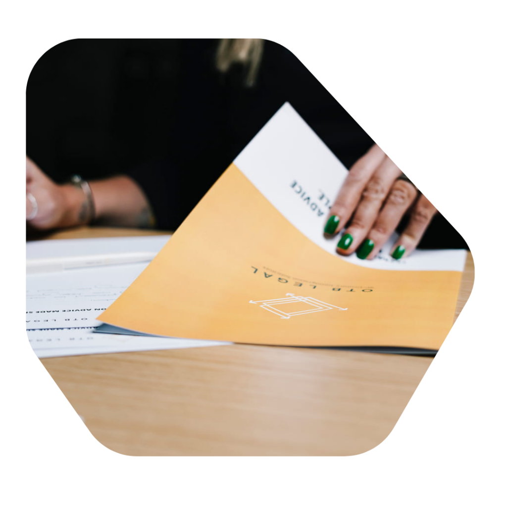 Female Solicitor holding an OTB Legal brochure. British Citizenship for Child born in the UK Lawyers