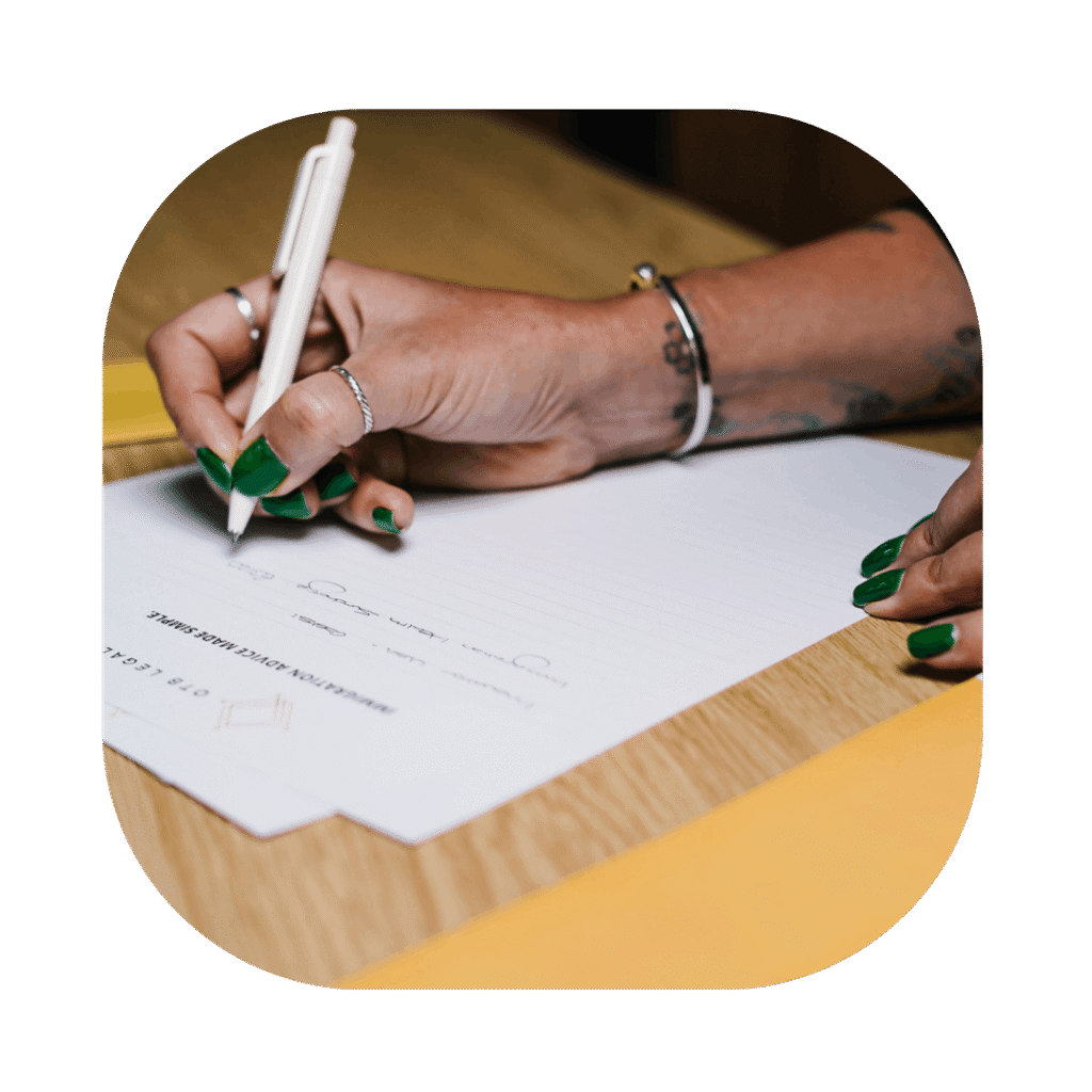 Womans hand writing on OTB Legal Document. Fee Waiver Application Lawyers UK