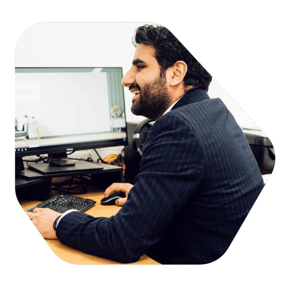 Male Solicitor at desk working on Refugee Settlement ILR Application