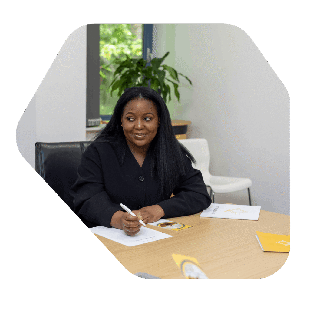 Female legal staff at desk taking notes. Refugee Settlement ILR Solicitors UK