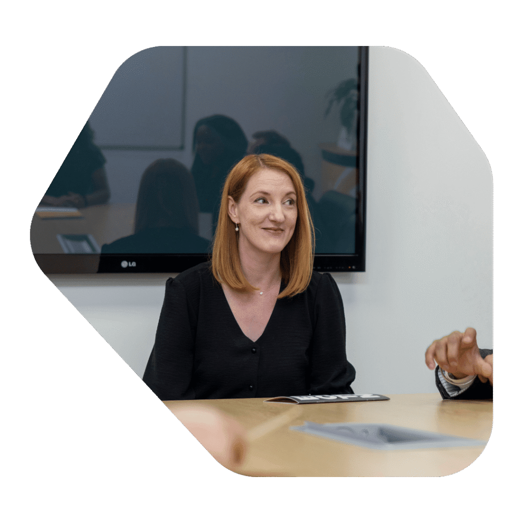Immigration Lawyer Cheadle sat at desk smiling.